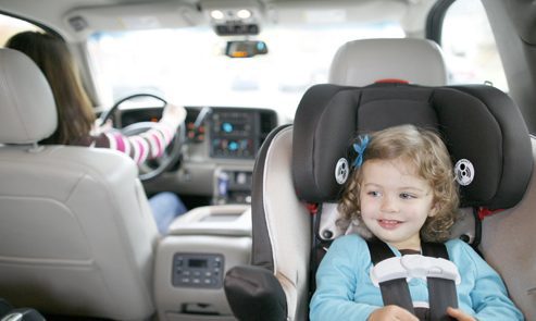 Young girl riding in rear-facing car seat