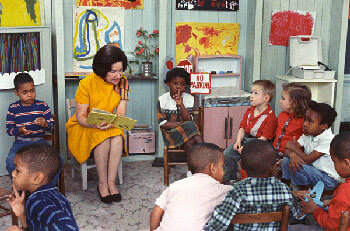 Lady Bird Johnson reads to children in a Project Head Start classroom, March 19, 1966. (National Archives)