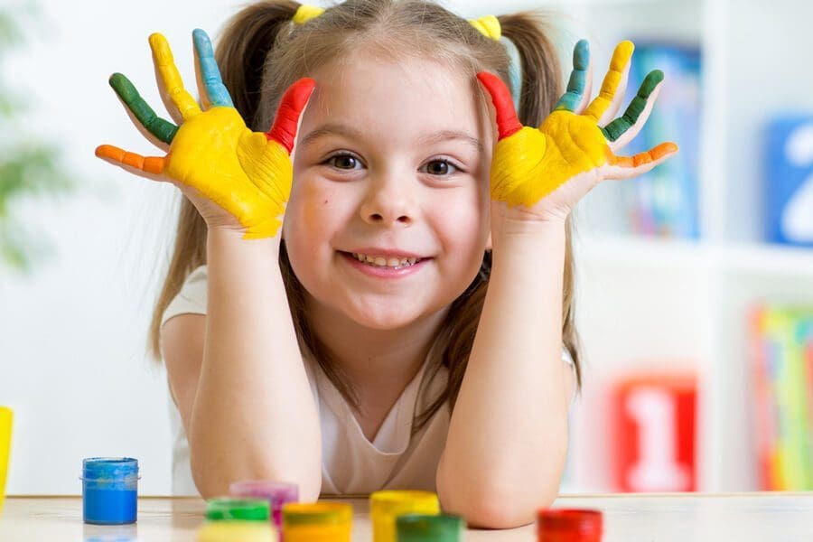 Little girl with finger paint covering her hands