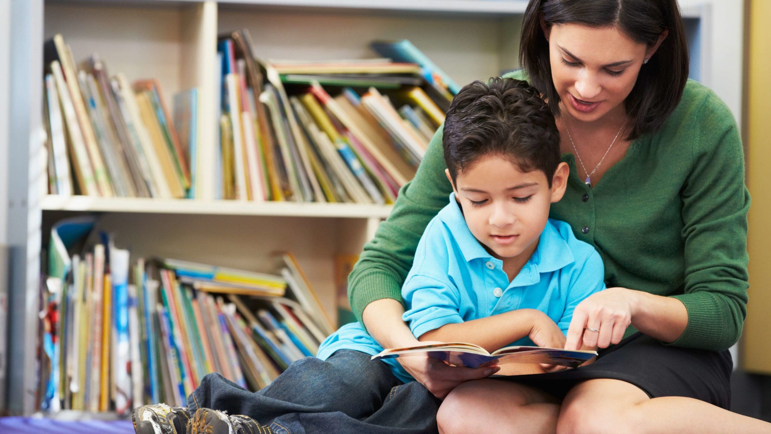 Woman and boy reading a book Woman and boy reading a book