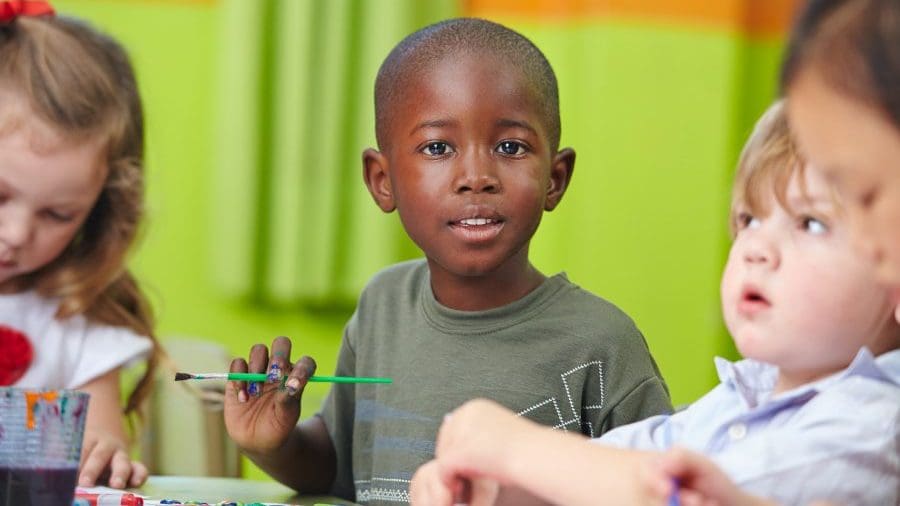 children painting at a table