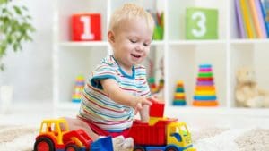 Child playing with blocks and toy trucks