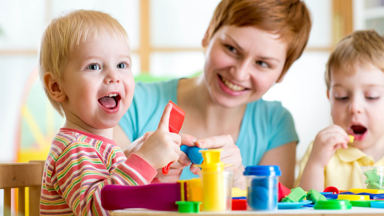 teacher playing blocks with children