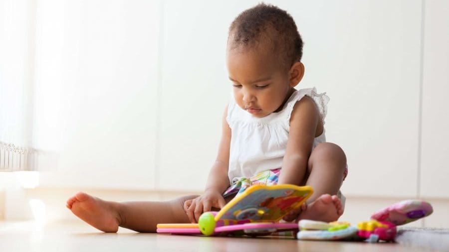 Baby reading a book on the floor Baby reading a book on the floor