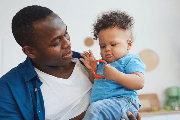 father and son playing with toy father an