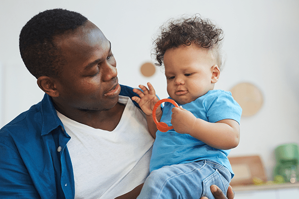 father and son playing with toy