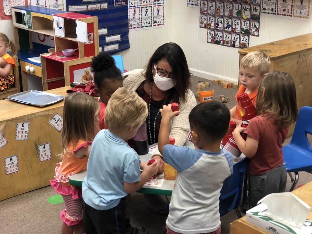 A child care director play with children in her child care center during COVID-19.