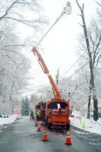 utility workers fix power line in ice storm