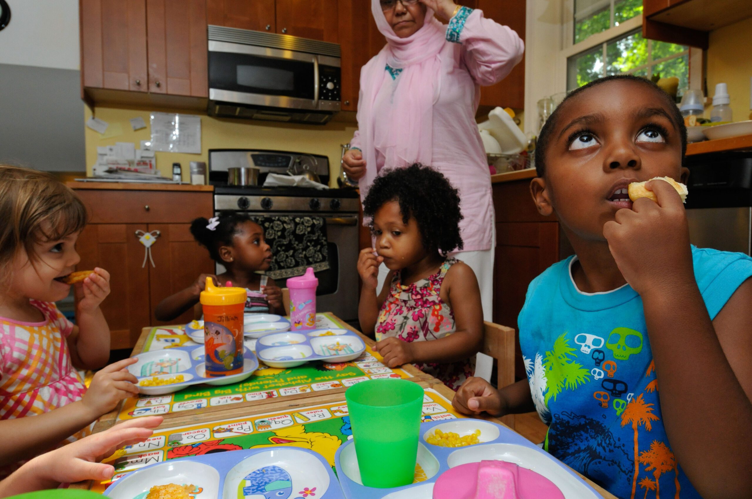 children gathered to eat in a family child care program