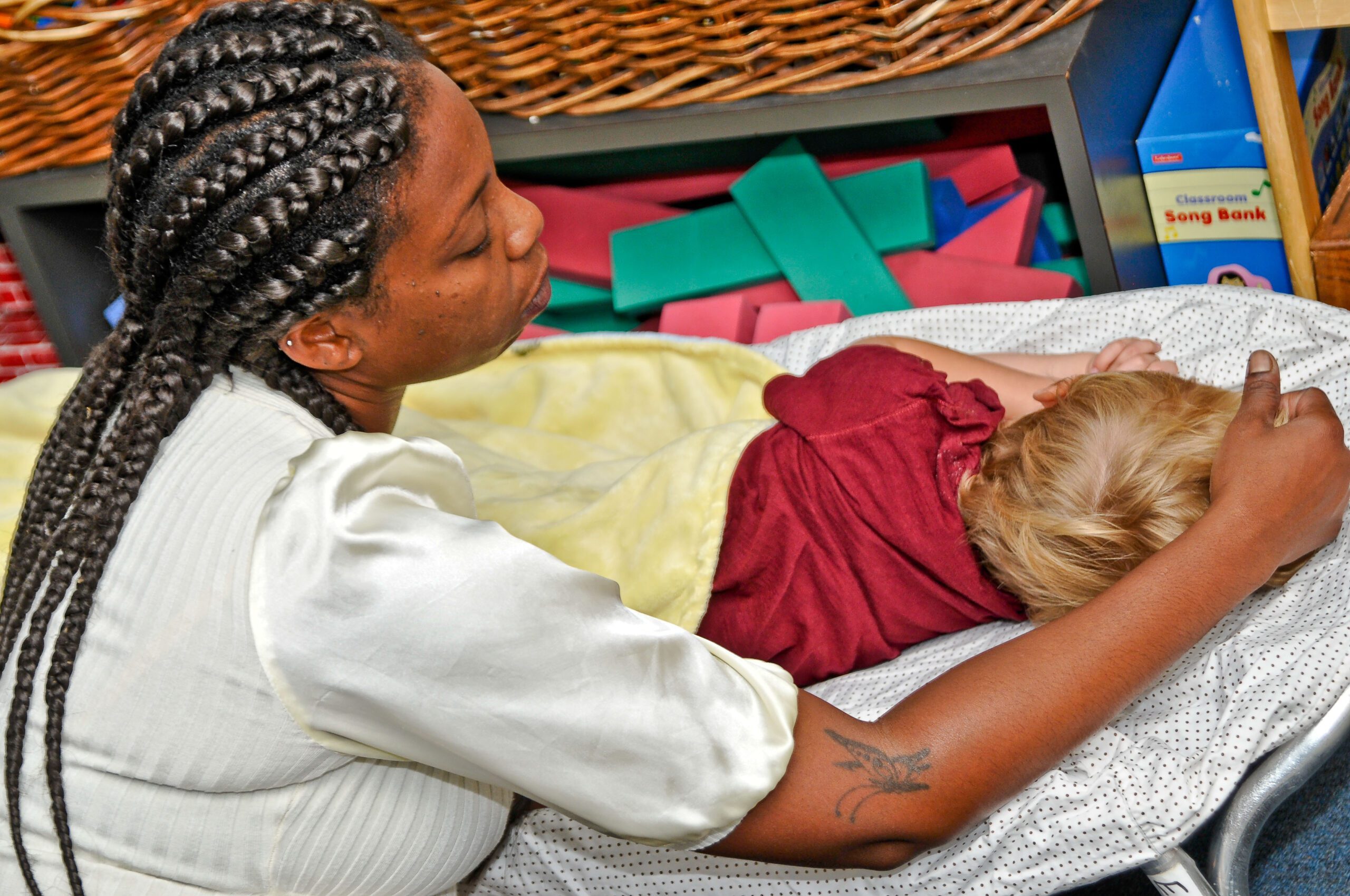 Provider calms a child during naptime