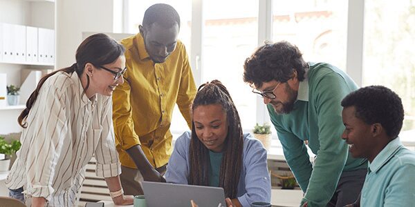 diverse-business-team-collaborating-in-office-327AN59