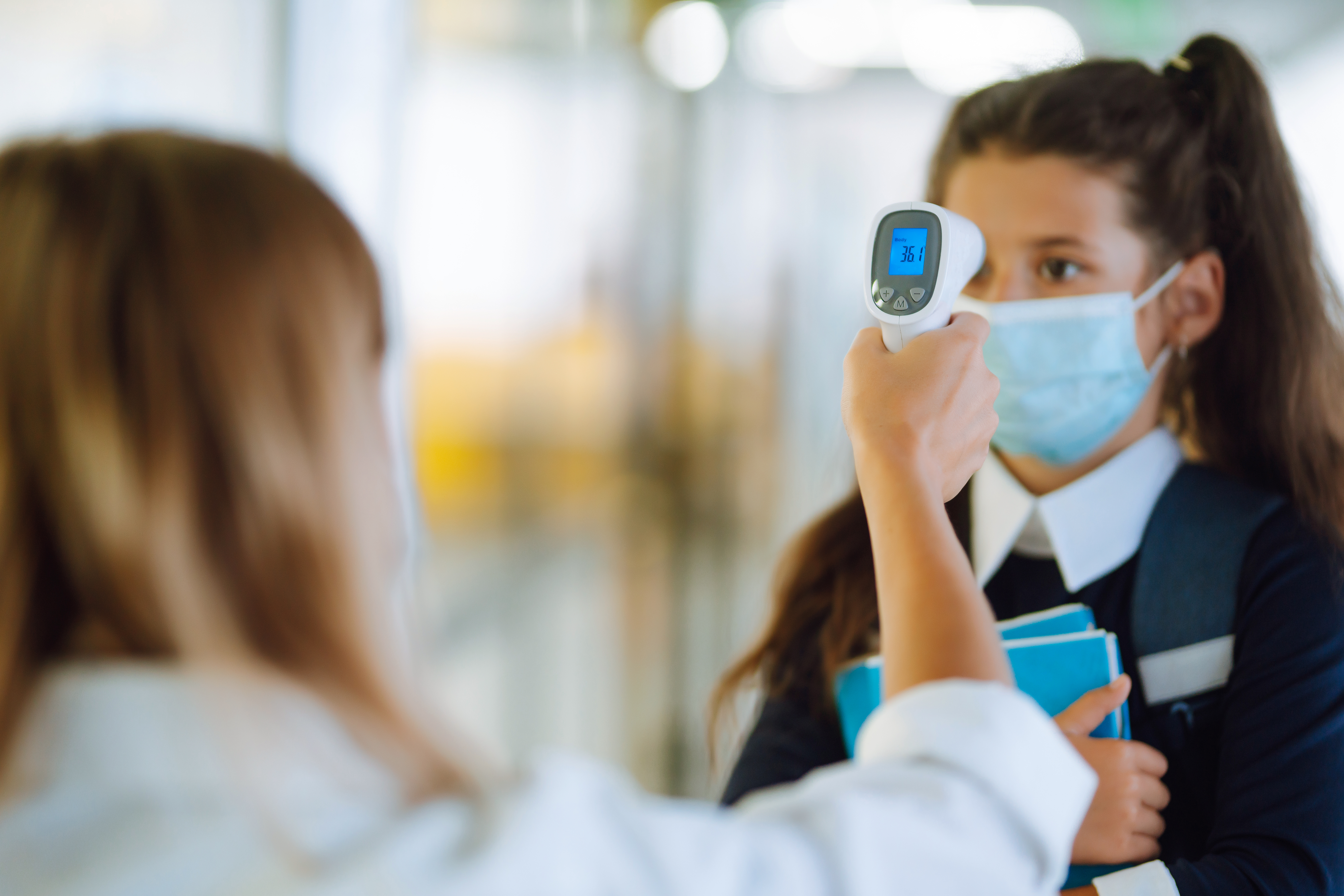 Nurse,Or,Doctor,Checks,Children,Body,Temperature,Using,Infrared,Forehead