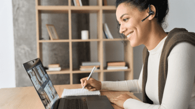 woman on video call taking notes